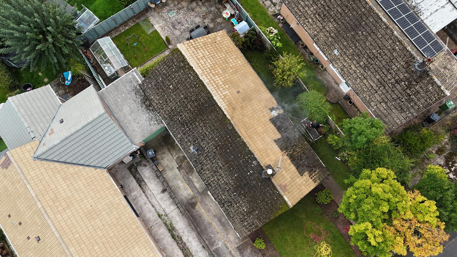 Professional roof cleaning in progress — before and after